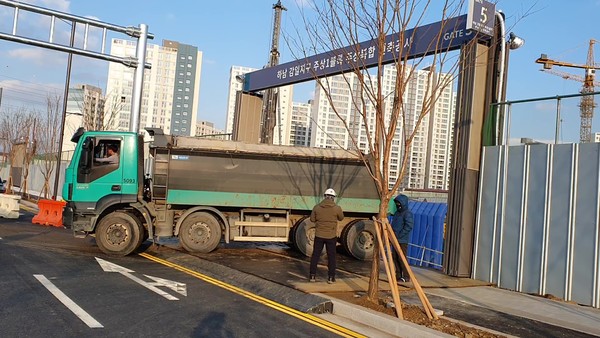 세륜 세척 행위를 무시하고 현장을 빠져 나가는 공사차량(사진=이영진 기자)